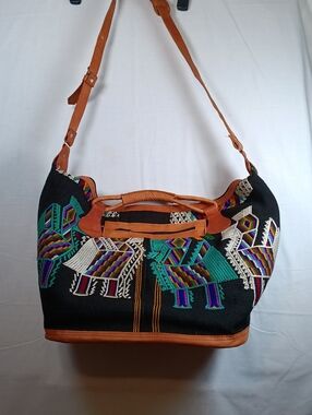 Hand Woven Travel Piece With Leather Strapping.